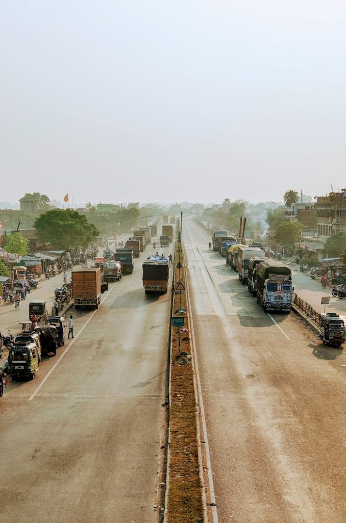 A bustling Indian highway showcasing heavy vehicles and traffic in Piprakothi, India.